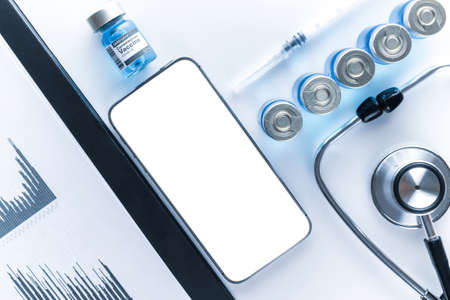Smartphone mockup. Doctor stethoscope, hospital healthcare charts, syringe with needle and black smartphone with blank screen on medical equipment background. For design application, website projectの写真素材