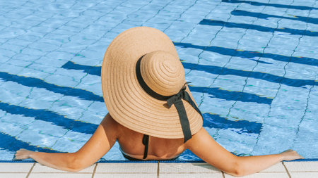 Happy girls pool. Young sexy woman in Sun hat, bikini swimsuit, sunglasses swimming in blue water....