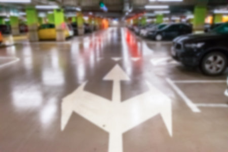 Parking lot blurred. Car lot parking space in underground city garage. Empty road asphalt background...