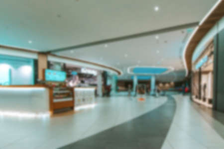 Customer store blurred background. People shopping in modern commercial mall center. Interior of retail center store in soft focus. Luxury inside business hallの写真素材