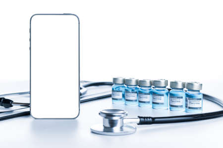 Medical application. Hospital equipment: doctor stethoscope, healthcare charts, syringe with needle and black smartphone with blank screen. Mockup generic deviceの写真素材