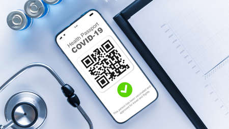 Medical equipment with Coronavirus vaccine certificate on phone screen, healthcare charts, syringe and doctor stethoscope on hospital white background. Digital passport conceptの写真素材