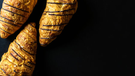 Croissant texture. French breakfast growing, fresh pastry bread with chocolate in bakery on dark...
