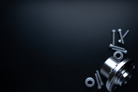 Spare parts. Auto motor mechanic spare or automotive piece on dark background. Set of new metal car part. Flat lay, top view, copy spaceの写真素材
