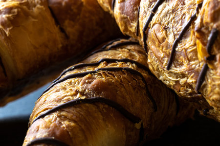 Croissant french. Fresh pastry bread or french breakfast growing with chocolate in bakery on black stone table. Homemade croissants, best for coffeeの写真素材