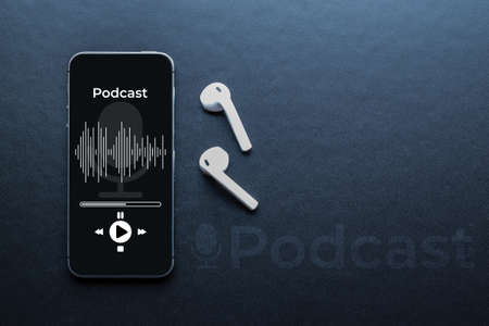 Podcast background. Mobile smartphone screen with podcast application, sound headphones. Audio voice with radio microphone on black. Recording studio or podcasting banner with copy spaceの写真素材