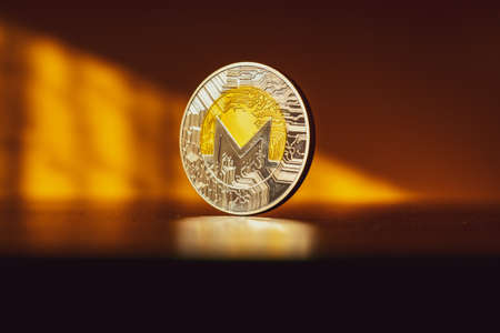 Monero icon. Gold Crypto currency BTC Bitcoin on black background. Golden Bit Coin virtual cryptocurrency or blockchain technology. Trading on the cryptocurrency exchangeの写真素材