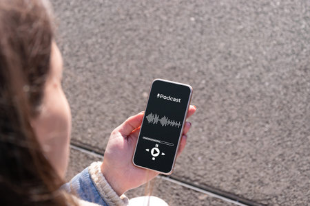 Podcast audio equipment. Audio podcast application on mobile smartphone screen in woman hand. Happy...