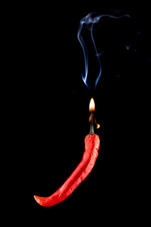 Cayenne chilli. Red hot chili paprika with hell flame, white smoke or spicy chile cayenne pepper...