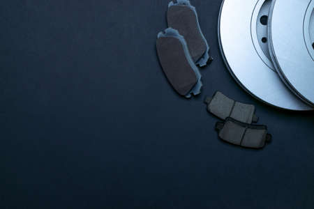 Spark plugs. Auto motor mechanic spare or automotive piece on black background. New metal car part. Flat lay, top view, copy spaceの写真素材