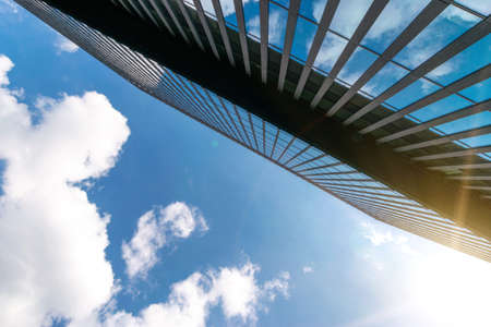 City buildings work. Modern office business building with glass, steel facade exterior. Finance corporate architecture city in abstract blue sky with nature cloud in sunny dayの写真素材