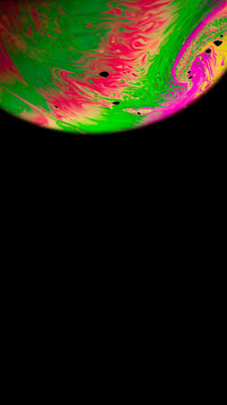 Bubbles macro. Globe planet earth in galaxy universe space with abstract sun on black background. Macro of oil mixed with waterの写真素材