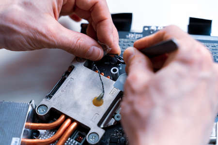 Computer service. Technology repair of pc electronic equipment. Technician engineer man do maintenance of hardwareの写真素材