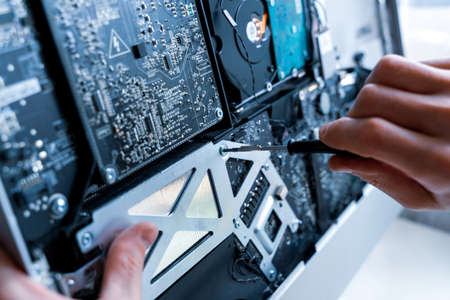 Technology repair of pc electronic equipment. Computer service. Technician engineer man do maintenance of hardwareの写真素材