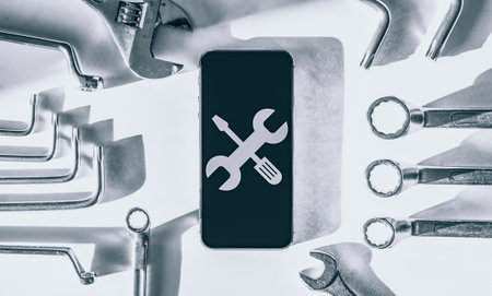 Repair phone. Technician workplace with phone and special repairing tools. Disassembling, diagnostic and repairman smartphoneの写真素材
