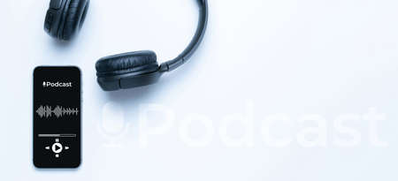 Podcast icon. Audio equipment with microphone, sound headphones, podcast application on mobile smartphone screen. Radio recording sound voice on white background. Broadcast media music conceptの写真素材