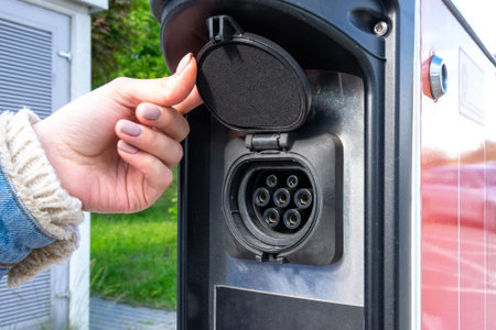Electric car charge. Power cable pump plug in eco green energy hybrid vehicle on future charger...
