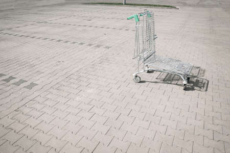 Shopping kart. Empty shopping trolley cart at supermarket parking lot. Sale buy mall market shop consumer conceptの写真素材