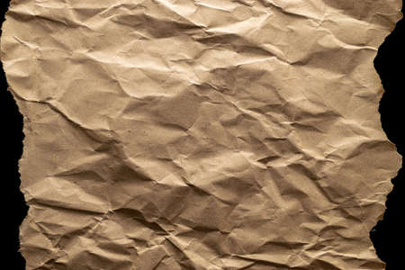 Torn craft paper. Old craft vintage cardboard isolated on black. Torn kraft paper texture background. Recycled material concept.の写真素材