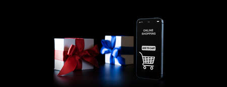 Black friday sale. Internet online shopping app on mobile phone, white gift box with red ribbon isolated on black background in Black Friday concept. Sale bannerの写真素材