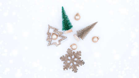 Christmas decoration snow. Happy new year ornament with golden balls, xmas holiday tree. White winter snow background. Minimal flat layの写真素材