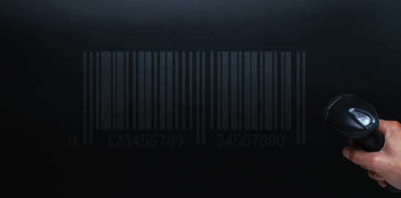Barcode concept. Retail label barcode scan. Reader laser scanner for warehouse on black background. Warehouse inventory managementの写真素材