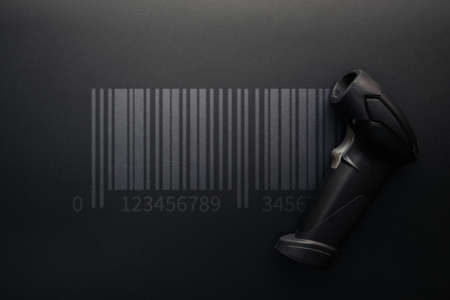 Barcode concept. Retail label barcode scan. Reader laser scanner for warehouse on black background. Warehouse inventory managementの写真素材