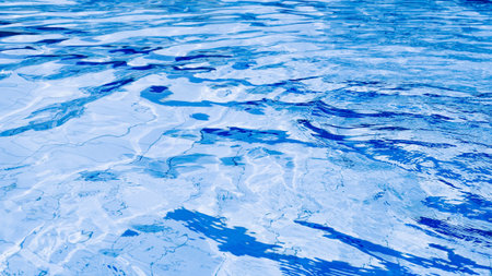 Water background texture. Blue wave pool surface. Summer sea abstract pattern