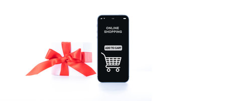 Christmas sale. Internet shop application on digital smartphone screen with gift box red ribbon in online shopping composition. Buy presents, prepare to xmas, among gift boxes and packagesの写真素材