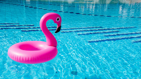 Flamingo icon. Pink inflatable flamingo in pool water for summer beach background. Minimal summer...