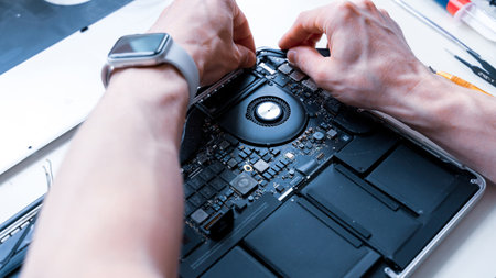 Computer repair services. Maintenance engineer support. Pc technician service with laptop on hardware technology background. Developer soldering electronic componentのeditorial素材