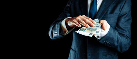 Counting euro. Rich businessman holding hundred money of Europe. Money Euro bill backgroundの写真素材