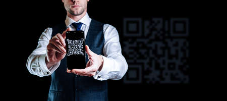 Qr code mobile. Digital mobile smart phone with qr code scanner on smartphone screen for online pay, scan barcode on black background. Qrcode payment, online shopping, cashless technology conceptの写真素材