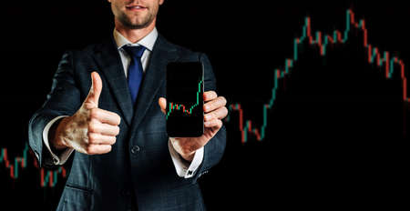 Shares financial. Businessman holding finance application for sell, buy and analysis profit dividend statistics. Investment business technology app on digital screen. Business graph backgroundの写真素材
