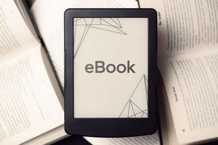 Readers. Digital e book, library reader tablet with books on dark background. Ebook, e learning electronic internet mobility conceptの写真素材