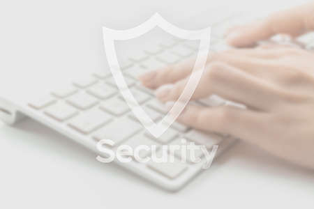 Safety computer security concept. Internet protection symbol on blured keyboard background. Concept image of security vulnerability and information leaksの写真素材