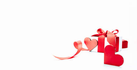 Valentine greeting card. Red heart, romantic gift with red ribbon on love white background. Valentines day decoration card with copy spaceの写真素材