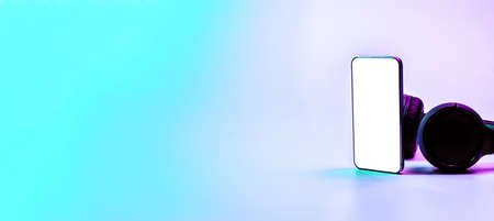Screen mockup. Mobile smartphone technology blank screen. Mock up smart phone device, audio headphones on neon gradient banner. Game design, mobile application presentation or portfolio mockupsの写真素材