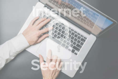 Internet security computer data symbol on blured keyboard background. Hacker attack and data breach, information leak conceptの写真素材