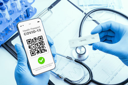 Coronavirus passport doctor holding. Covid vaccination certificate or vaccine passport on smartphone...