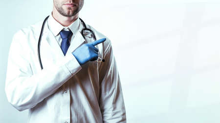 Doctor gesture hands medical background. Happy nurse in blue gloves, hospital uniform, stethoscope isolated on white. Close up, copy space backgroundの写真素材