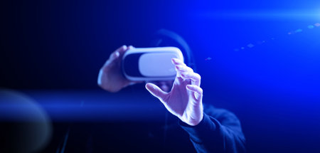 Vr headset virtual reality. Model young in digital glasses for 3d virtual reality game on dark background. future tech experience conceptの写真素材