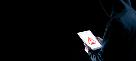 Hacker tablet cyber security. Digital mobile phone in hacker man hand isolated on black banner....