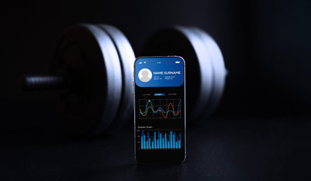 gym app. Smartphone screen with sport gym or fitness health mobile application on black dumbbell...