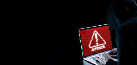 Hacker security cyber attack. Digital laptop in hacker man hand isolated on black. Blurred internet web hack technology with glitch effect. Login and password, cyber security banner conceptの写真素材