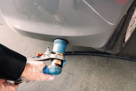 Pumping gas fuel car at oil station. Woman hand refuel petrol nozzle tank. Refueling transportation...