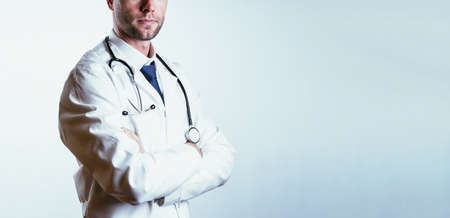 medical doctor hospital background. Happy nurse in hospital uniform, blue gloves holding patient clipboard isolated on white. Medical care, insurance, prescription, paper work or career conceptの写真素材