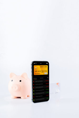 mobile banking network. Smartphone with internet online bank application. Piggy bank with debit card...