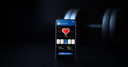 fitness application. Smartphone screen with sport gym or fitness health mobile application on black dumbbell background. Online fitness programの写真素材