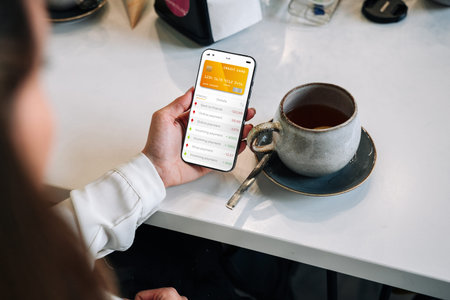 online payment. Woman holding smartphone with internet online bank application. Debit card wallet...